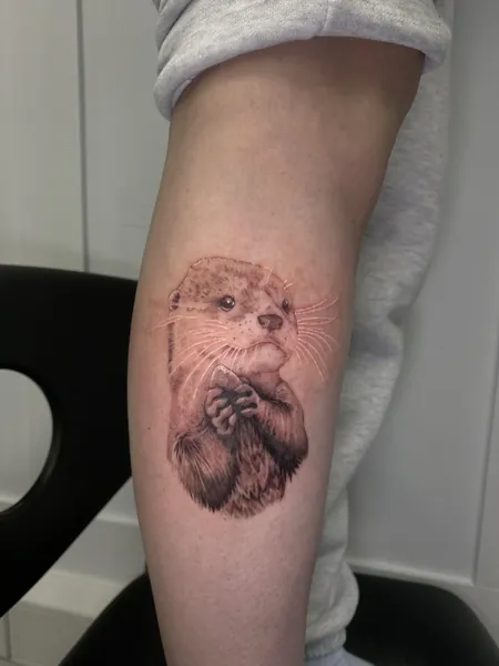 Otter with pebble — black and grey realism tattoo by Lewis Zangaro, The SelfMade Tattoo Company, Wolverhampton