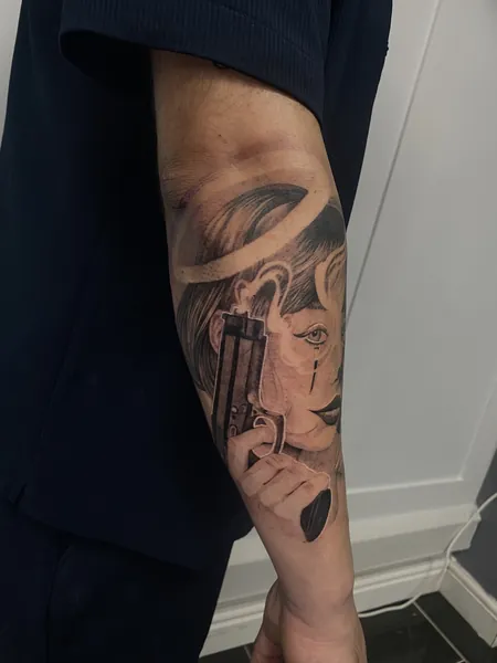 Woman with gun — black and grey realism tattoo by Lewis Zangaro, The SelfMade Tattoo Company, Wolverhampton