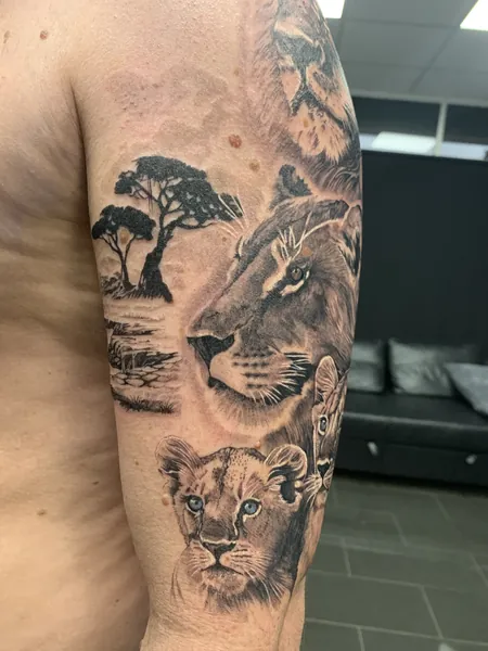 Lion pride and landscape — black and grey realism tattoo by Lewis Zangaro, The SelfMade Tattoo Company, Wolverhampton