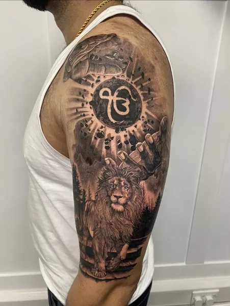 Lion and ek onkar — tattoo by Lewis Zangaro, The SelfMade Tattoo Company, Wolverhampton